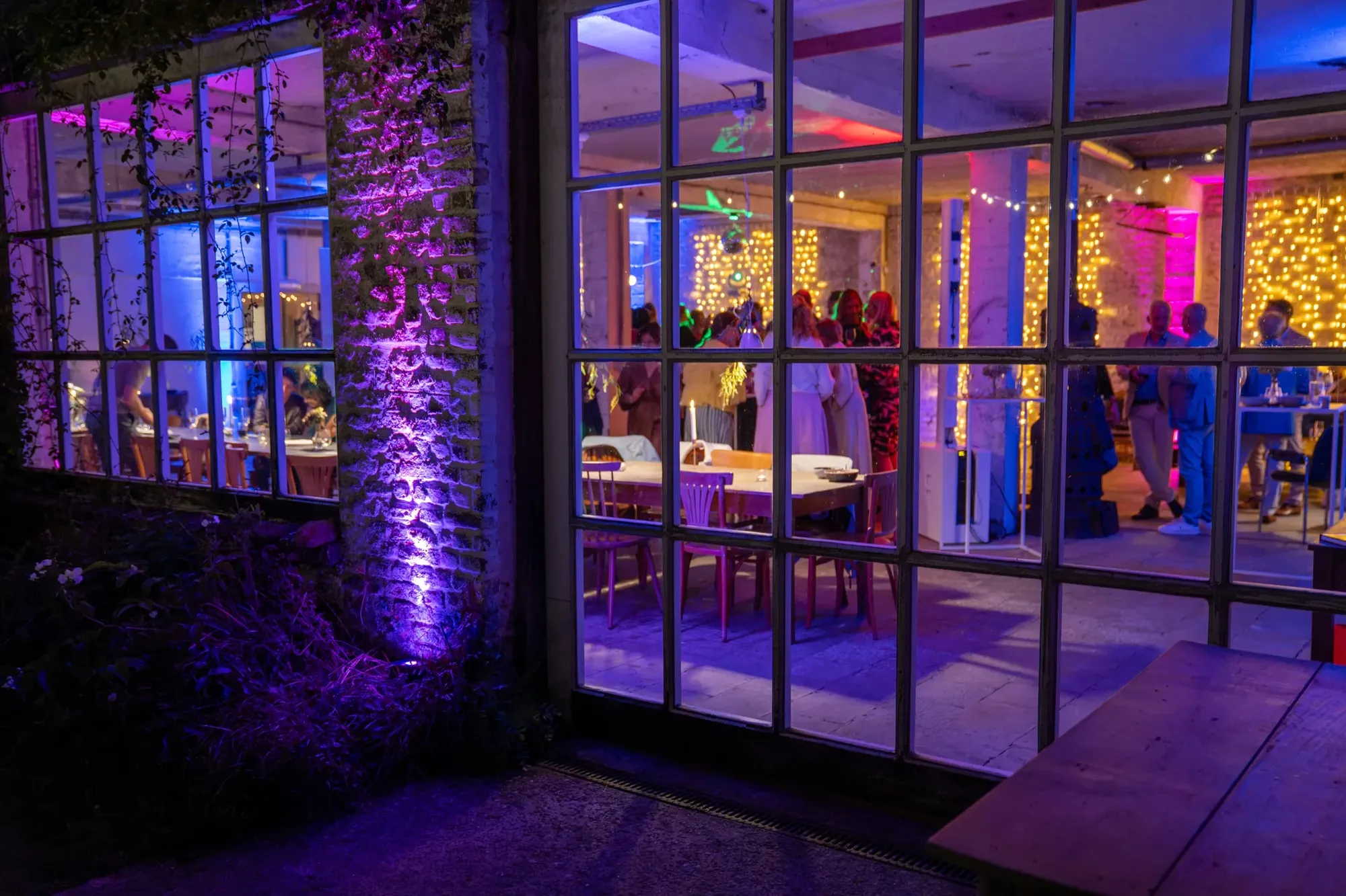Party venue at night with mood lighting and guests